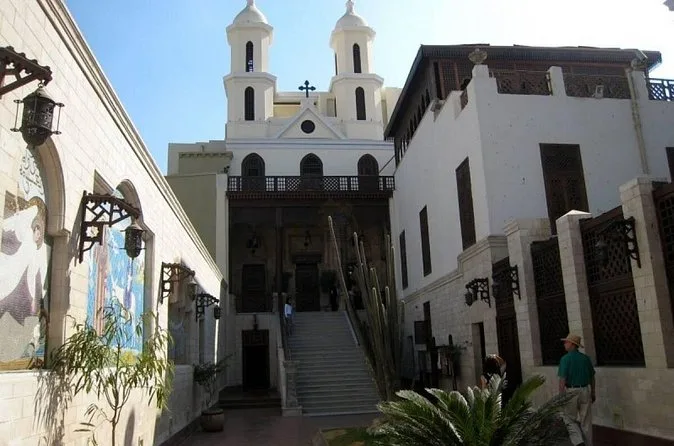 Stone steps leading up to the Hanging Church in Coptic Cairo, with white towers above